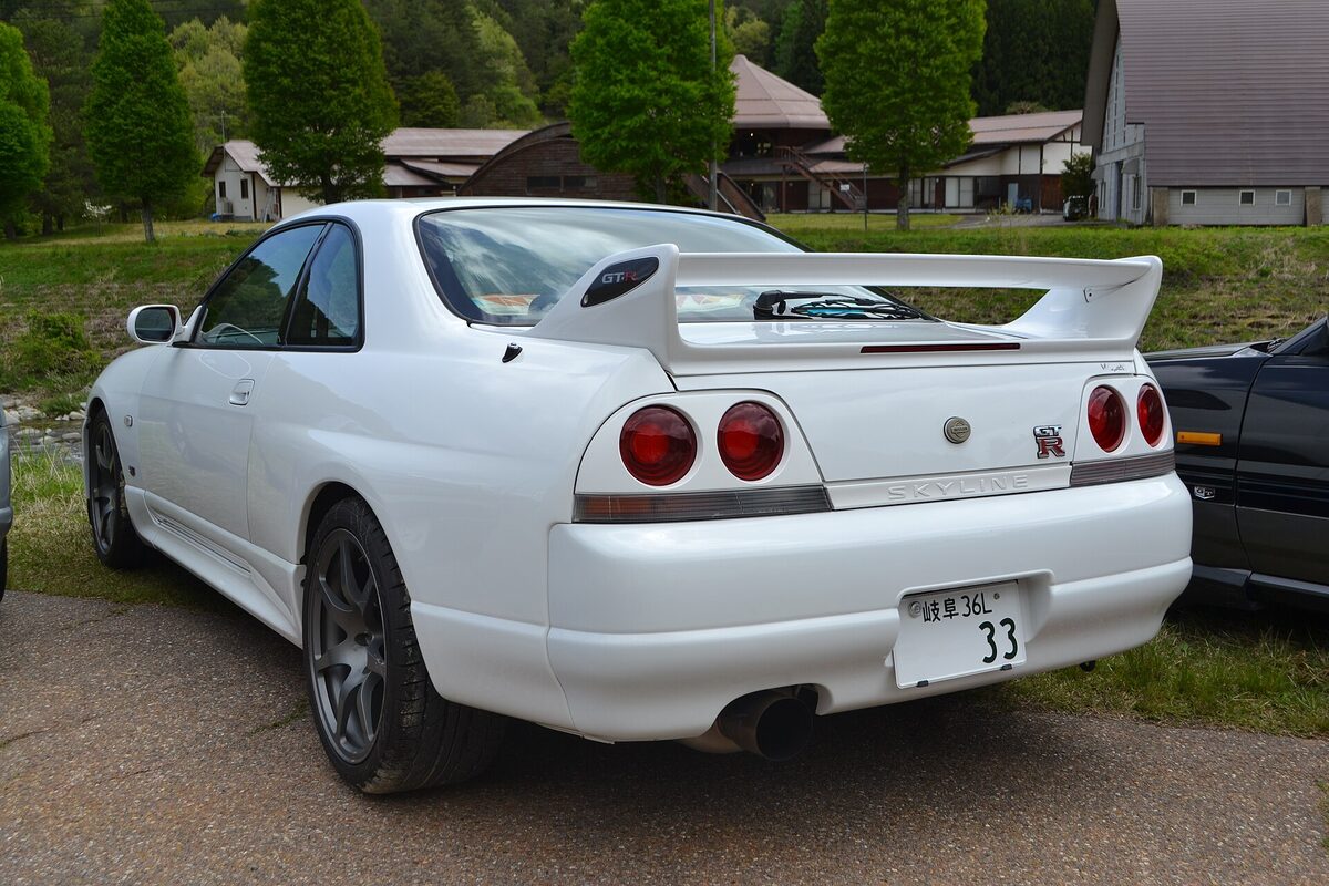 Rear three-quarter view of a white Nissan Skyline R33 GT-R
